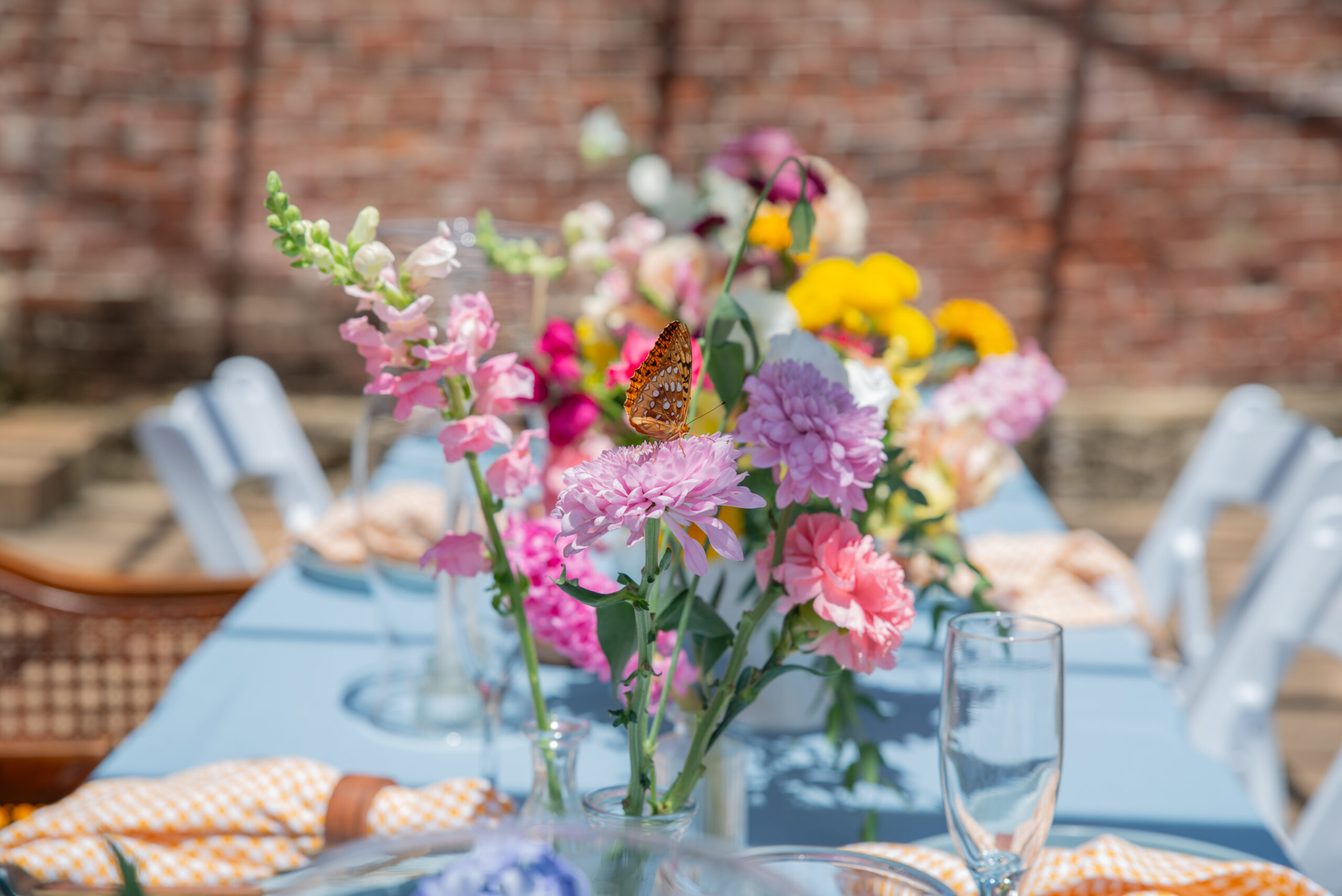 butterfly sits on flowers during wedding reception